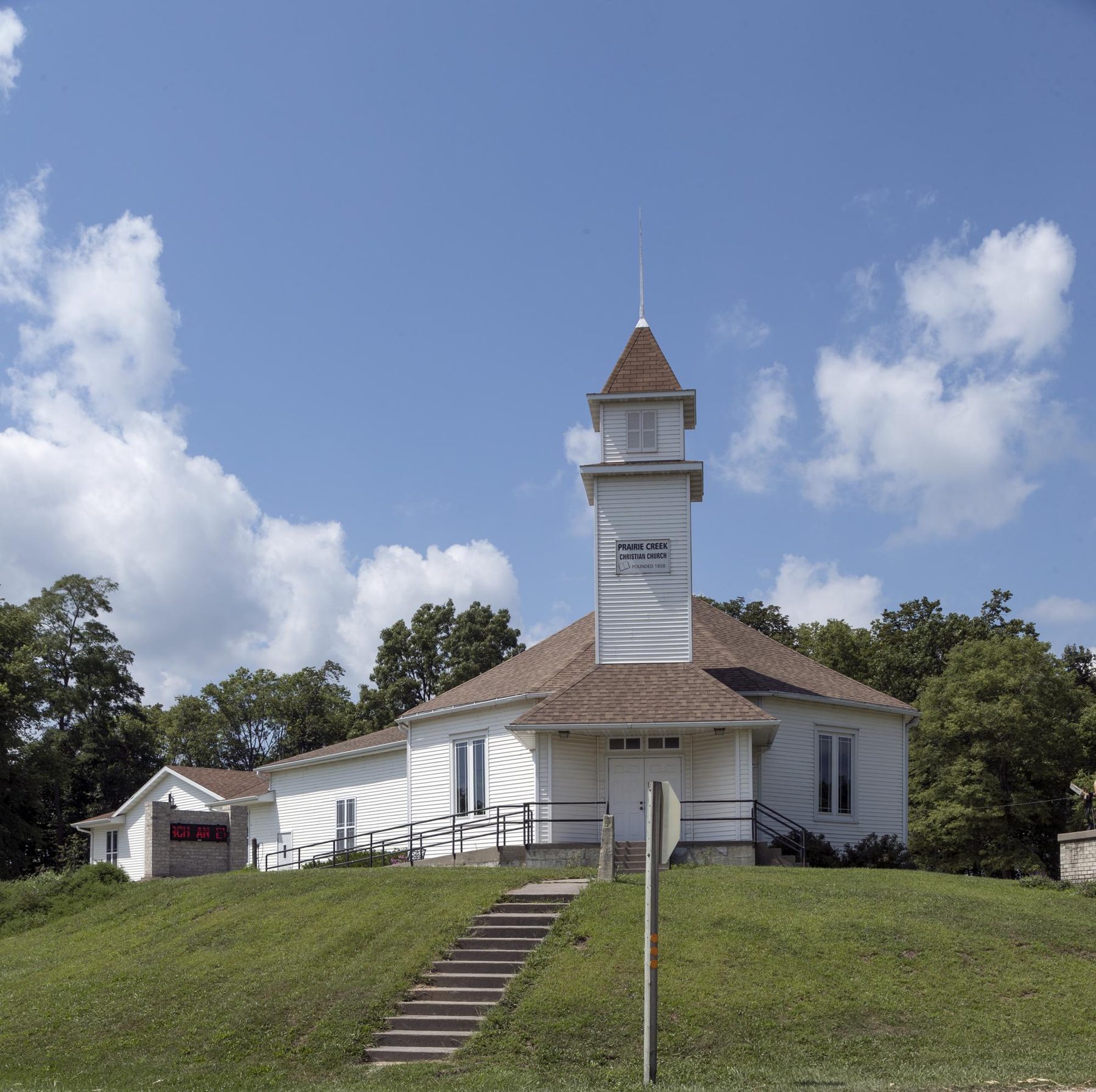 A small white country church on a hill in rural Benton County, Iowa